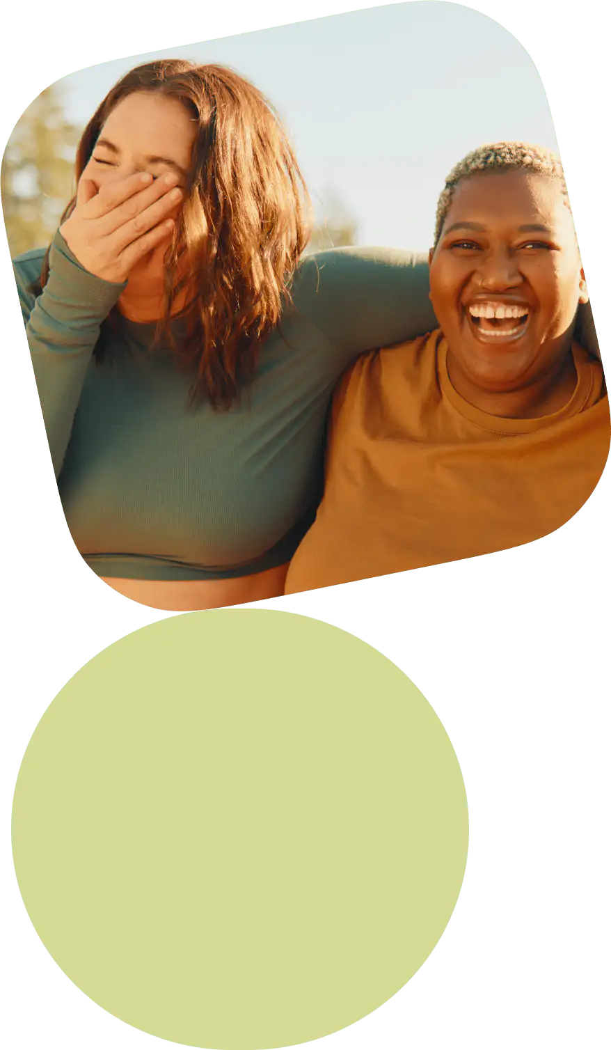 Two women sharing a joyful moment, laughing and embracing each other with genuine happiness.